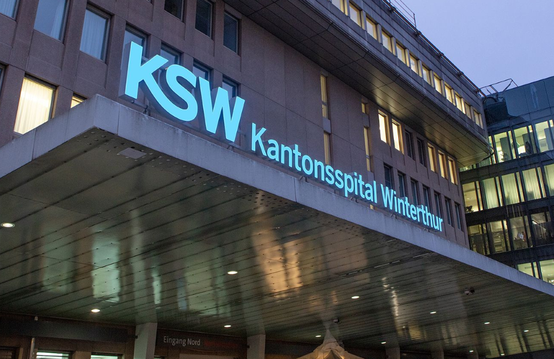 Entrance of the Cantonal Hospital Winterthur (KSW) at dusk, where Alex Nelles, as Chief Information Officer and Executive Board Member, leads the digital transformation of one of Switzerland’s top 10 hospitals, revolutionizing business processes and patient administration to enhance healthcare outcomes.